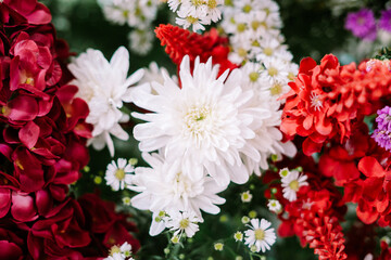 Fresh white and red flowers are used for wedding decorations.