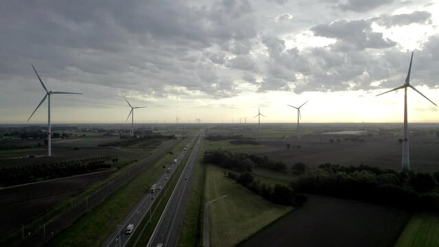 This drone footage presents a striking aerial view of the E19 highway as it stretches from Antwerp towards Breda, captured near Brecht. The video highlights the seamless integration of modern