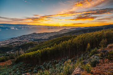 beautiful sunset over the city of Funchal on Madeira from the location Miradouro do Pico Alto....