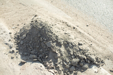 Dust on road. Pile of garbage on side of road. Cleaning track.