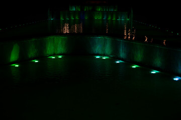 Colored fountain at night. City Fountain with Illumination. LED Water Light.