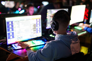 Teenager boy gamer play video game on PC computer