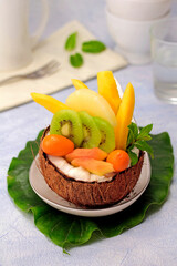 Tropical fruit salad in a coconut.