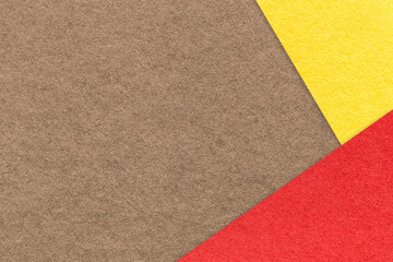 Fototapeta premium Texture of craft brown paper background with yellow and red border. Vintage abstract umber cardboard.