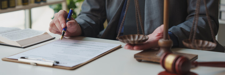 A lawyer or legal advisor prepares to sign legal contract documents. Managing a business with one...