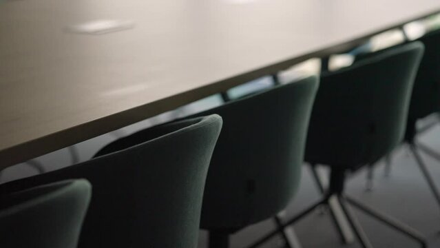 Close-up of Empty Modern Chairs by a Conference Table in a Meeting Room