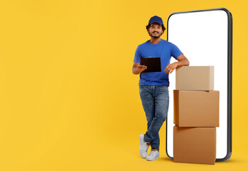 Courier with stack of parcels and clipboard near huge smartphone on golden background. Delivery service. Space for text