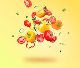 Different fresh vegetables in air on yellow background