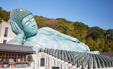 Large Buddha statue lying down with ancient Japanese monuments Japan