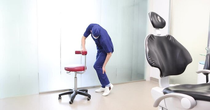 Standing dentist, dealing with calf pain.Symptoms and self help exercises, stretching.  Profile view.