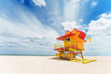 Vibrant, pastel view of lifeguard tower colorful painted colorful under bright blue sky on South Beach, Miami, Florida.