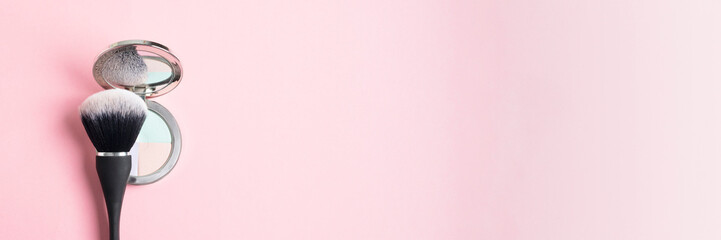 Abstract cosmetic banner, finish powder case and black brush on pink gradient background, make up product