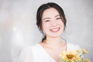 Cute woman with sunflower bouquet Close-up of a cute image for bridal, beauty or pre-shoots Looking...