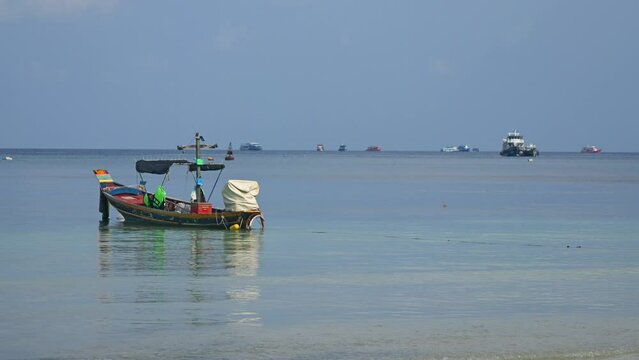 Slow motion cinematic view of traditional Thai baot on open ocean