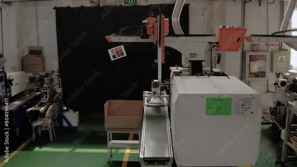 Aufkleber inside a chinese factory with an automated production system. plastic injection molding machine with