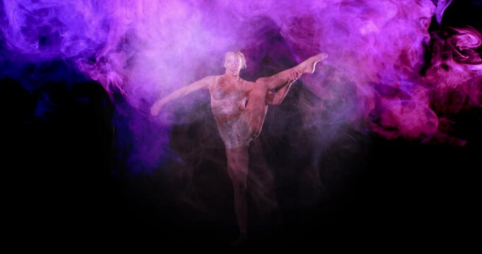Artistic pink and purple smoke around flexible acrobat, ballet moves with leg up