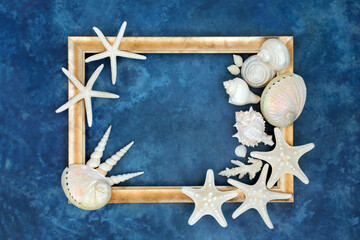 Seashell abstract with white shells on mottled blue background with gold frame. Nature design with...