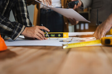 architect or engineer working on table use drawing tool on the paper plan for business architectural project.