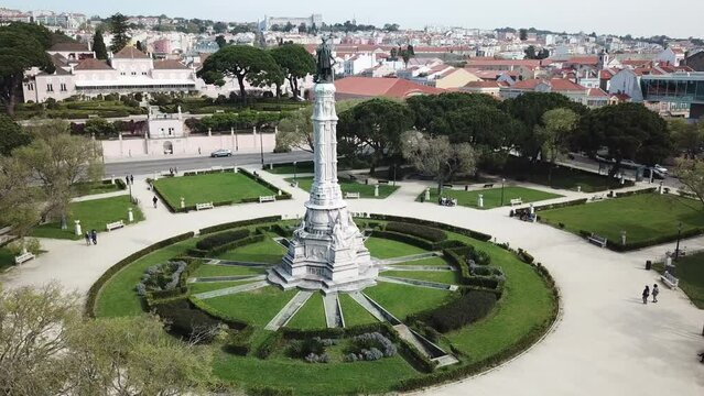 Belem, Afonso de Albuquerque's Statue's drone footage starts from left hand side and moves slowly towards right from a perfect angle where full size of the statue and the park around it can be seen.