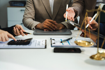 Business people and lawyers discussing contract papers sitting in the table at office in the...