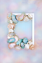 Shell and pearl abstract frame  on rainbow sky background with collection of mother of pearl...