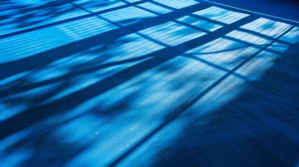 Detail of a vibrant blue sports court, featuring distinct lines and shadows, ready for athletic action.