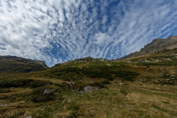 Fototapeta na wymiar Fluffy Clouds Above Vorarlberg's Mountains