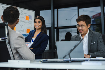 Business team working on a project in the office or reviewing and discussing a business project.