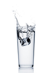 Water splash with ice cube in a glass isolated on white background