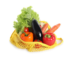 Fresh vegetables in yellow string bag isolated on white