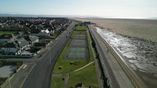 Hoylake Beachfront conservation area on a sunny afternoon - aerial drone flyover recreation area from Meols, Wirral, UK