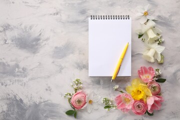 Guest list. Notebook, pen and beautiful flowers on gray textured background, flat lay. Space for text