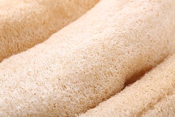 Natural loofah sponges as background, closeup view