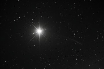 The stark contrast of a single bright star in a dark sky