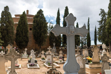 Crosses and cypresses in a cemetery. All Saints Day. 
