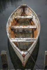 Wooden rowboat tied to a weathered dock