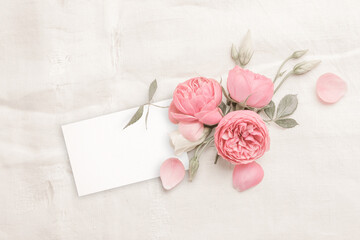 Pink Rose Flowers on Light Grey Linen Background with Copy Space. Blank Greeting Card Mock up. Romantic Vintage Wedding, Mother´s Day or Valentine Concept. 