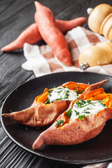 baked sweet potatoes on a dark wooden rustic background