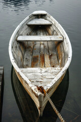 Wooden rowboat tied to a weathered dock