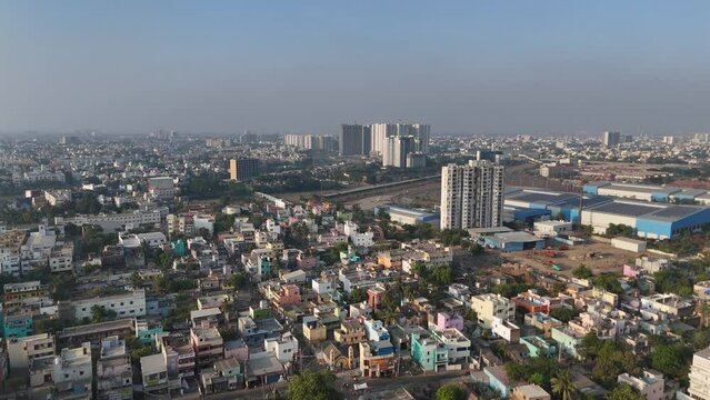 An enchanting drone shot of Chennai, highlighting the city's architectural marvels and vibrant street life against a backdrop of swirling clouds.