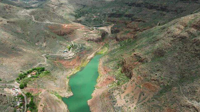 Fantastic aerial view over the Sorrueda dam on the island of Gran Canaria and seeing beautiful mountains and near the Ansite fortress. Spain.