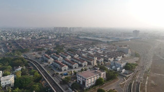 A mesmerizing aerial view of Chennai city, showcasing the vibrant street life and architectural wonders against a backdrop of drifting clouds.