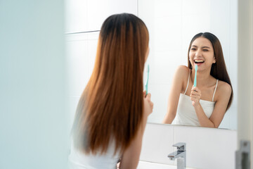 Young smiling asian woman holding brush teeth for the health of teeth in restroom. Take care and...