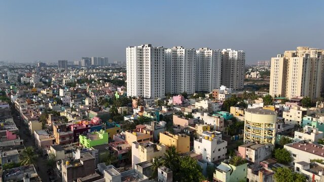 A captivating aerial perspective of Chennai, showcasing the convergence of modern infrastructure and traditional housing under a cloudy sky.