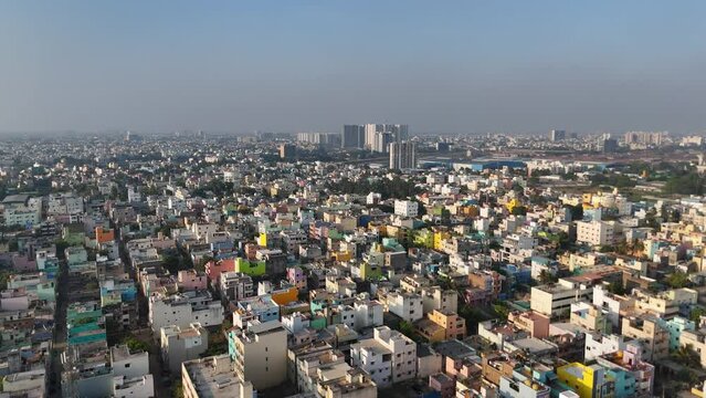 An enchanting aerial view of Chennai's cityscape, with clouds drifting lazily over the architectural wonders and bustling streets below.