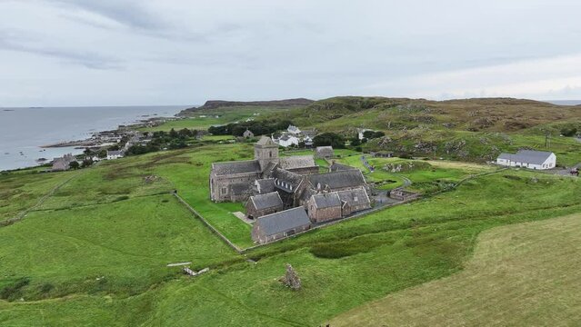 Drone Shot of Iona Island, Scotland UK, Abbey and Nunnery Building in Green Landscape