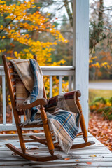 Wooden rocking chair on a porch with a cozy blanket