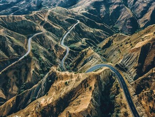 A mountain range with a winding road that is surrounded by trees