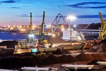 Dry bulk cargo terminal, handling coal at night.