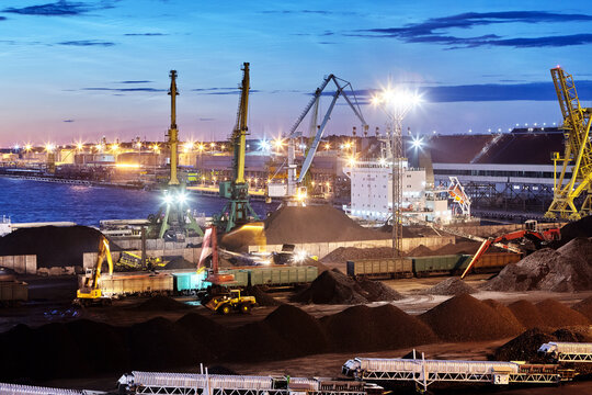 Dry bulk cargo terminal, handling coal at night.